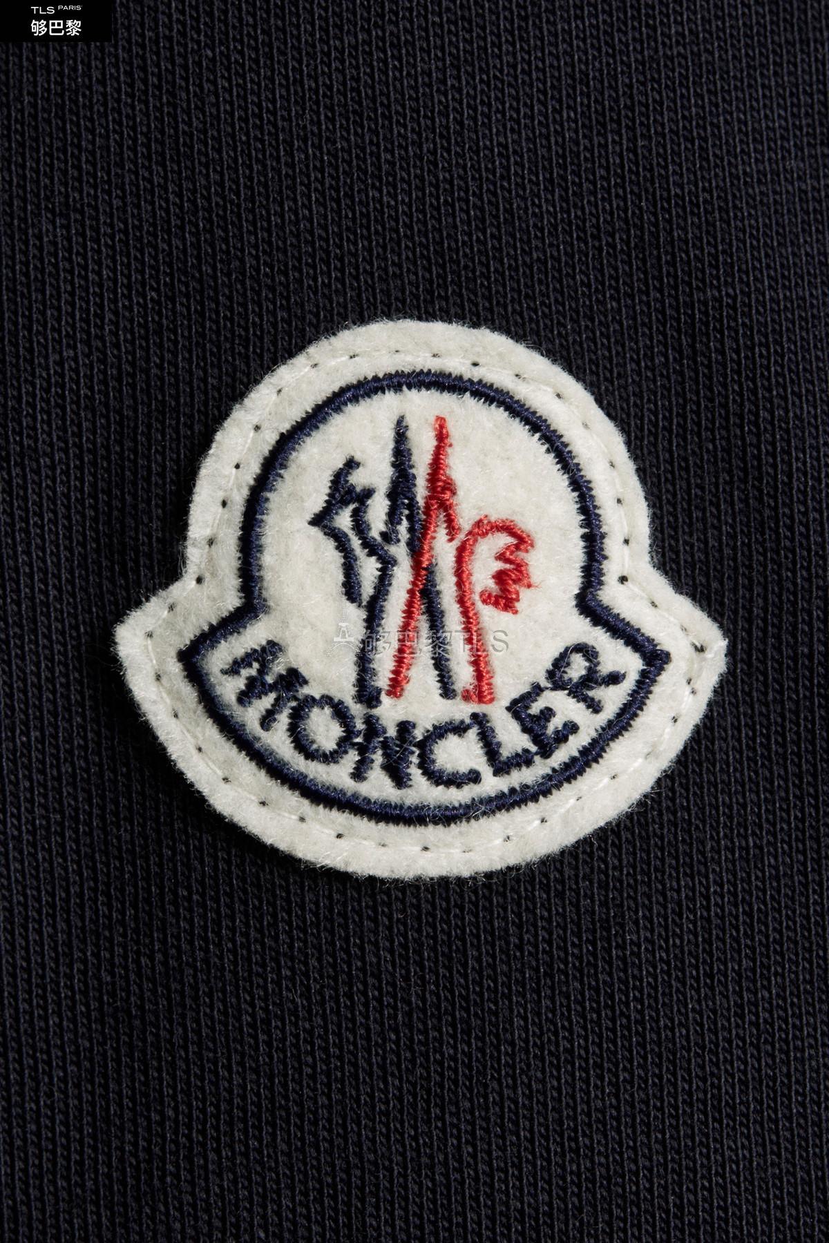 the tricolour band and the raised moncler logo on the chest